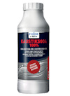 Vit flaska med mörk etikett märkt "KAUSTIKSODA 100%" och text om effektiv rengöring och niltning.